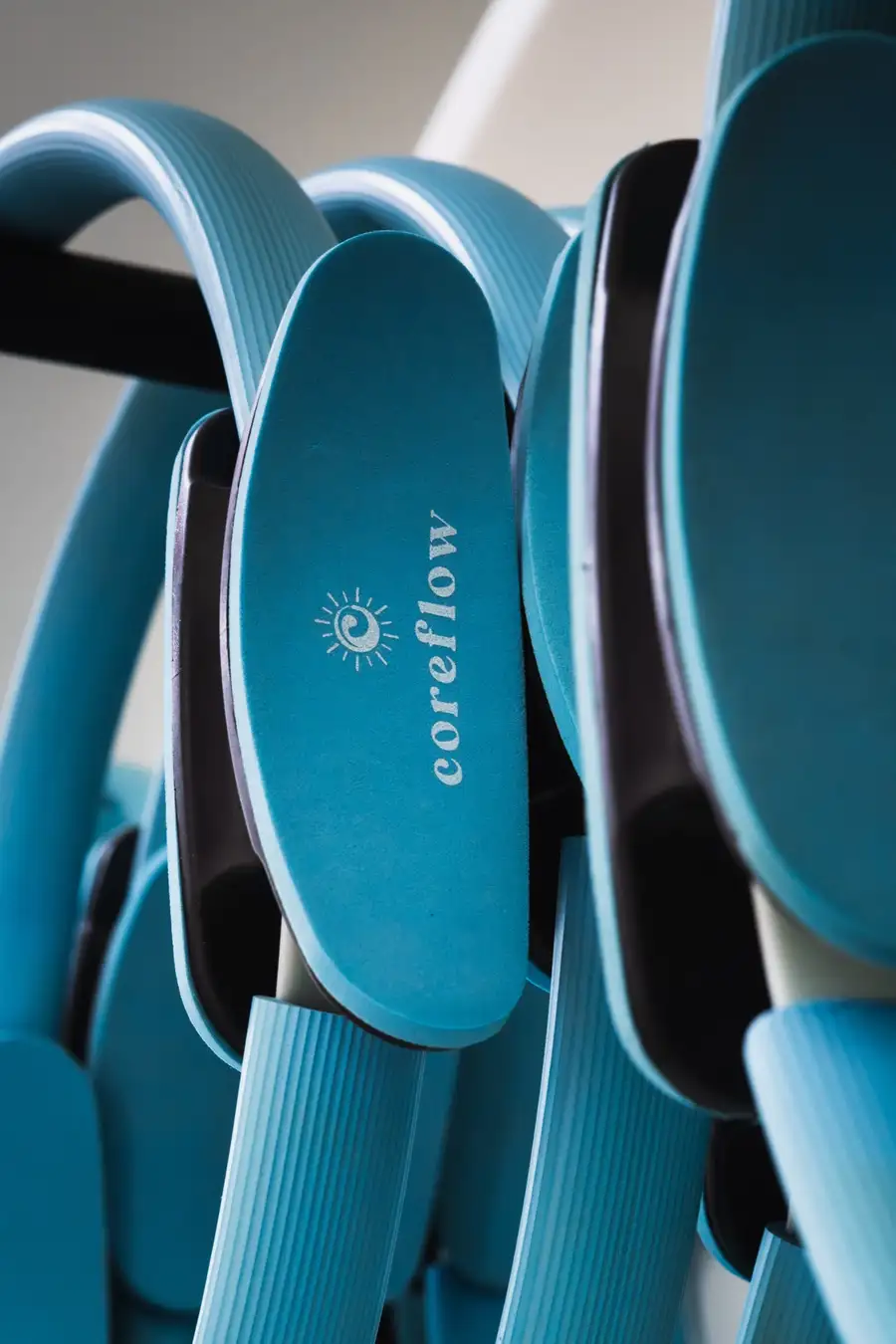 A stack of COREFLOW-branded pilates rings used in Powerhouse classes